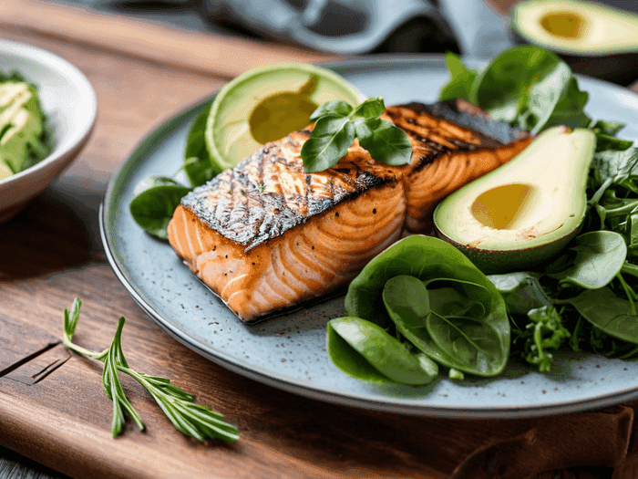 Colorful ketogenic meal with avocado, salmon and low-carb vegetables on modern plate